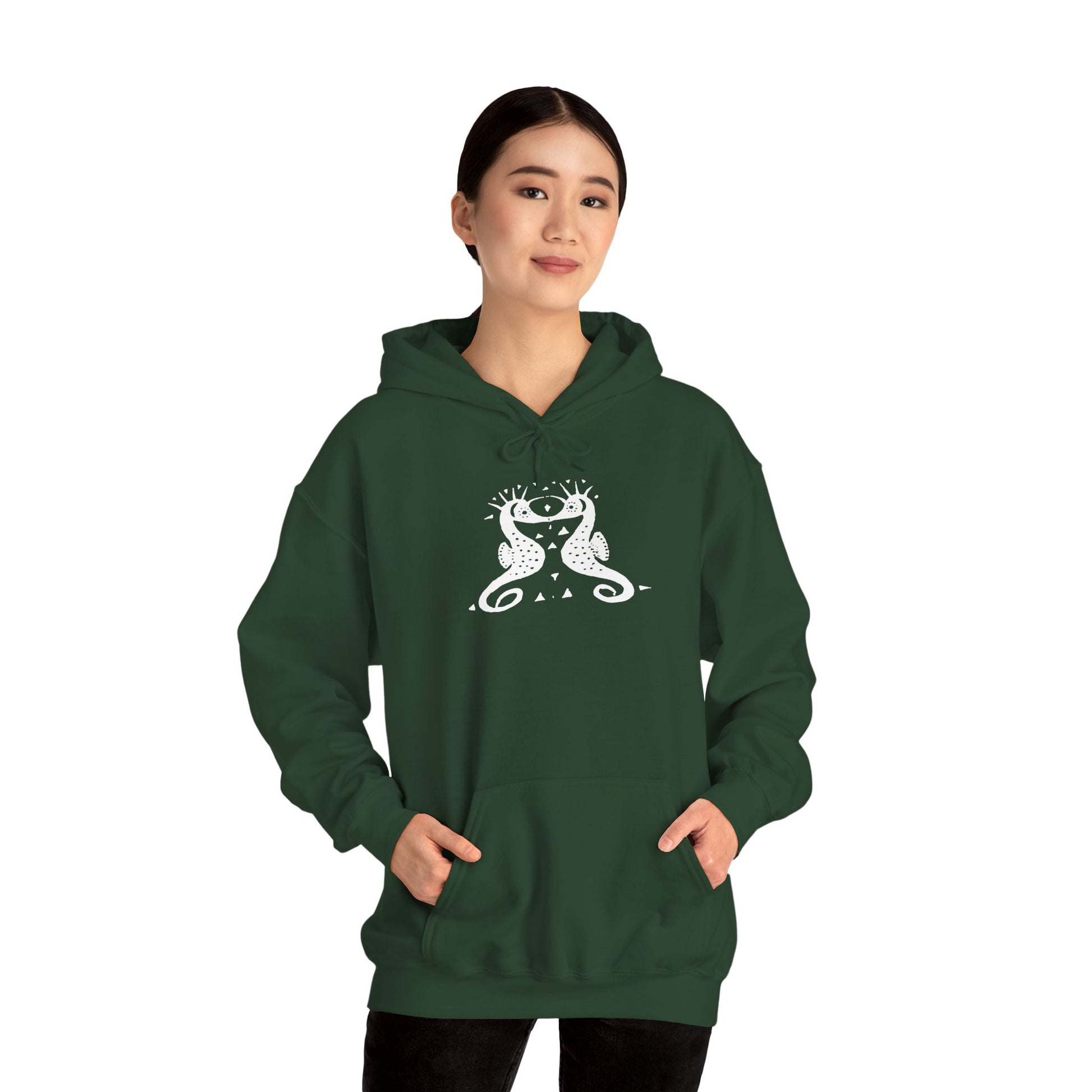 A woman wears a forest green hoodie with a white, art noveau style print of two seahorses facing each other. The seahorses are mirror images of each other.