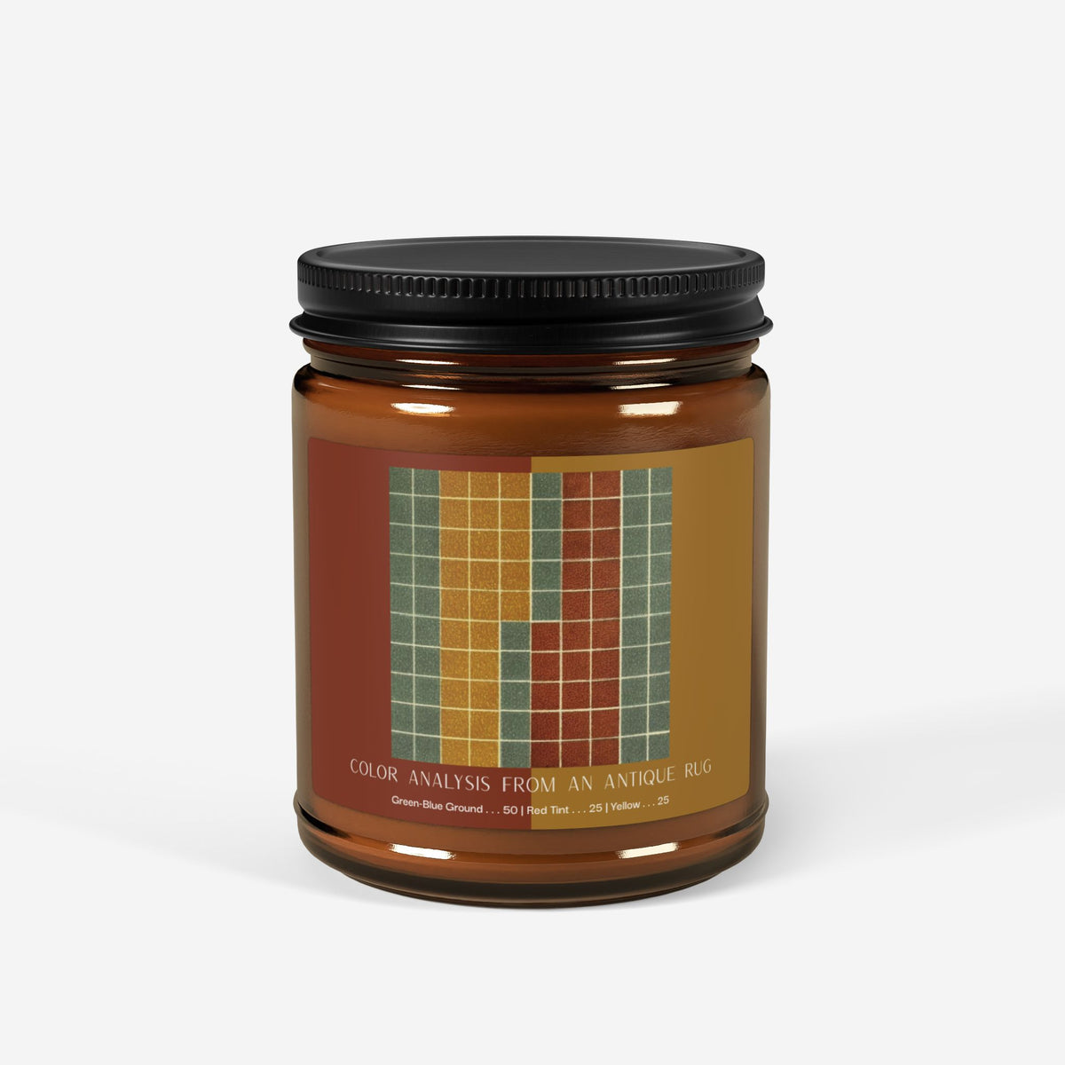 Amber glass candle jar with a black lid and a label showing a ten-by-ten grid of gray-green squares with vertical bands of golden yellow and brick red, titled Color Analysis from an Antique Rug.