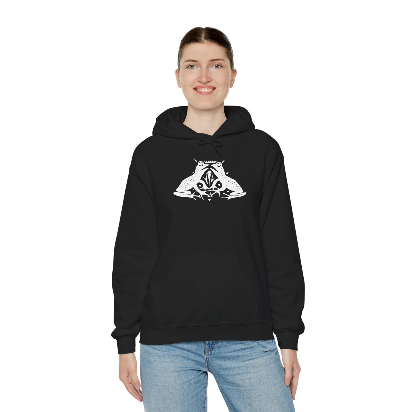 A woman wears a black hoodie with a white, art noveau style print of two frogs facing each other. The frogs are mirror images of each other.