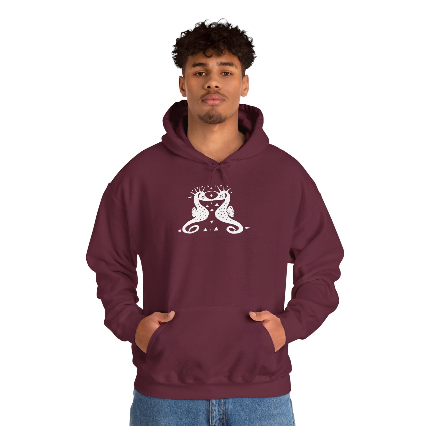 A man wears a maroon hoodie with a white, art noveau style print of two seahorses facing each other. The seahorses are mirror images of each other.