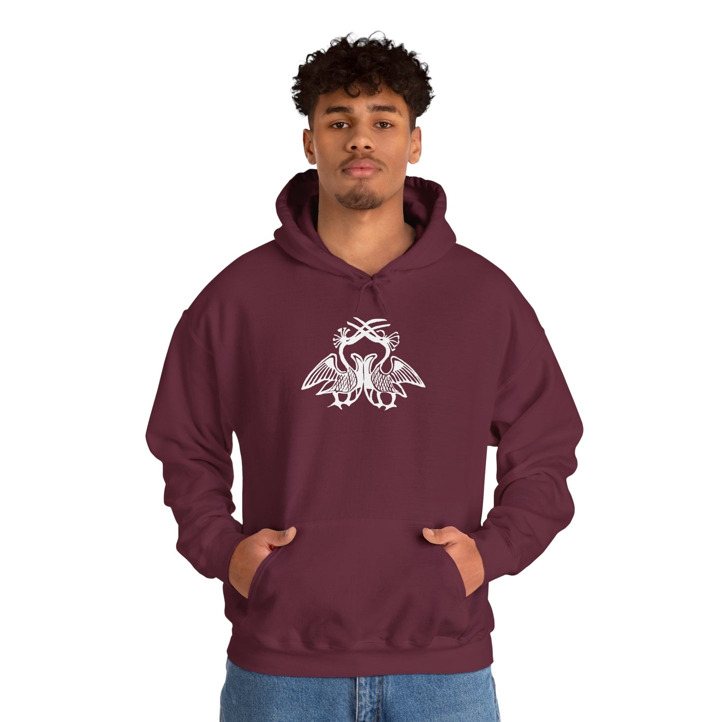A man wears a maroon hoodie with a white, art noveau style print of two birds standing face-to-face. The birds are mirror images of each other and their long beaks cross at the top of the design.