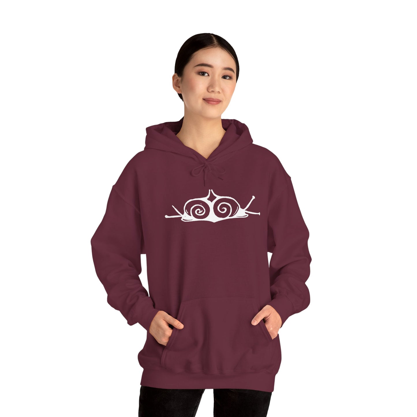 A woman wears a maroon hoodie with a white, art noveau style print of two snails facing away from each other. The snails are mirror images of each other and slightly overlap in the middle of the design.