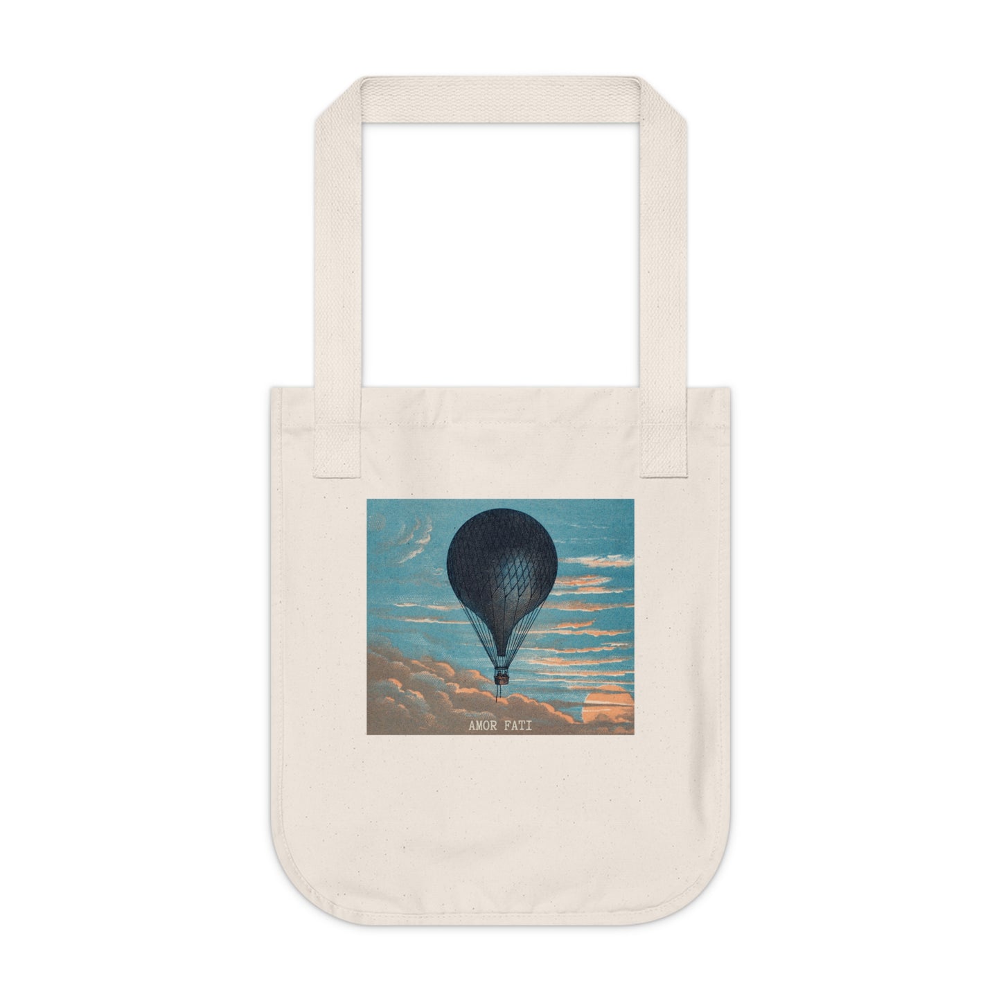 Natural canvas tote bag, front view, featuring a dark hot air balloon against a blue sky with peach-toned clouds, with the text "AMOR FATI" beneath.