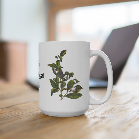 A white mug situated with the handle on the right. The visible face of the mug features a vintage botanical illustration of a white tea plant.