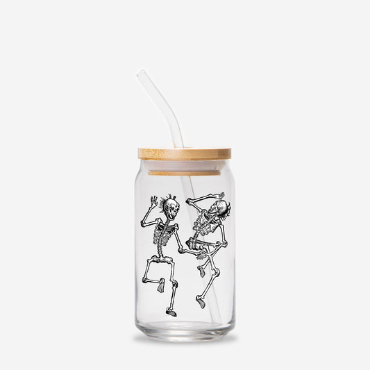 A can shaped glass with a bamboo lid and clear straw. Two vintage-style skeletons are dancing with each other on the front of the glass.